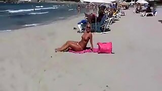 Tanning mother I'd like to fuck on beach is exhibitionist